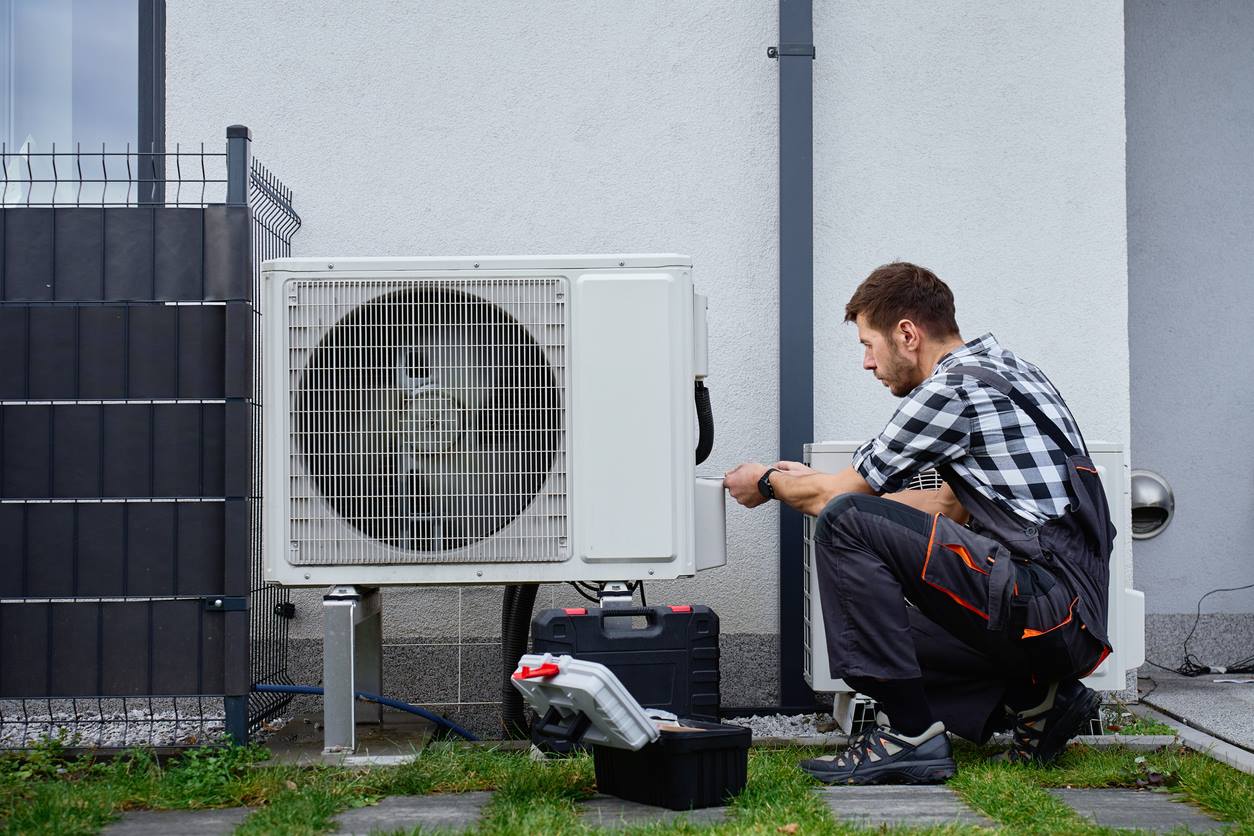 GreenShield technician installing a heat pump at a Long Island home